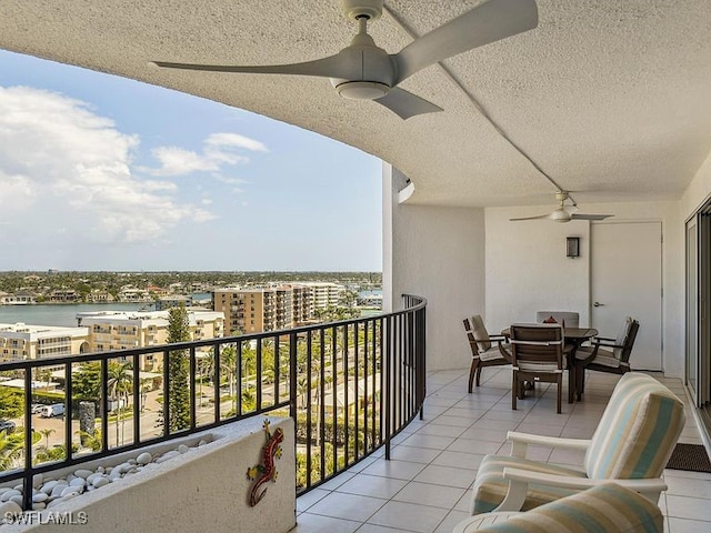 3951 Gulf Shore Blvd N Unit 1005, Naples, FL 34103 - balcony with a ceiling fan, a view of city, outdoor dining space, and a water view