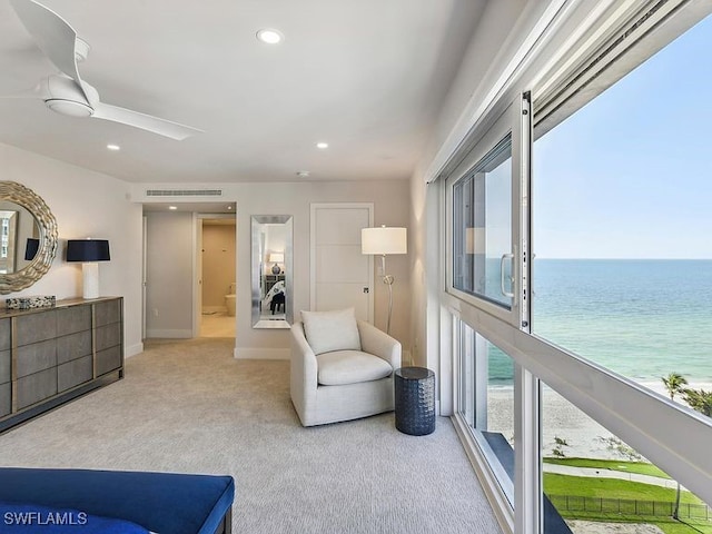 3951 Gulf Shore Blvd N Unit 1005, Naples, FL 34103 - sitting room with carpet floors, a water view, a ceiling fan, recessed lighting, and baseboards
