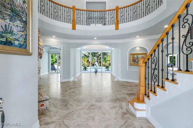491 Wedge Dr, Naples, FL 34103 - foyer with ornamental molding, arched walkways, stairway, a high ceiling, and recessed lighting