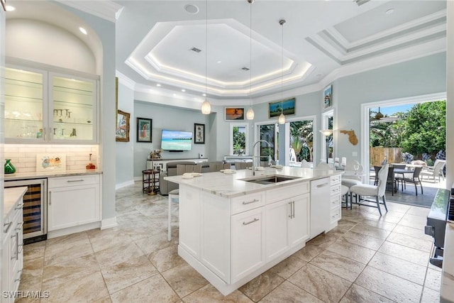 491 Wedge Dr, Naples, FL 34103 - kitchen featuring beverage cooler, ornamental molding, light stone countertops, white dishwasher, and a tray ceiling