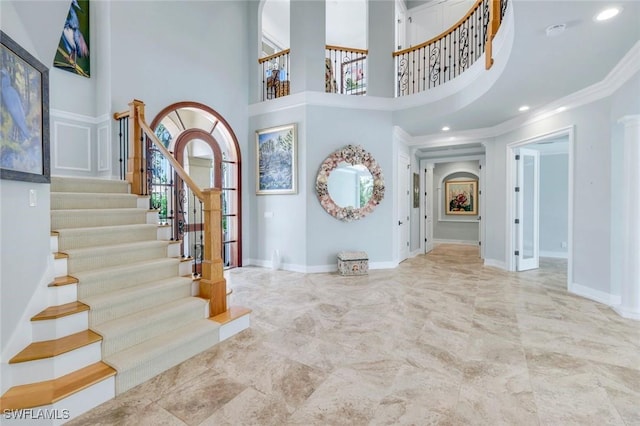 491 Wedge Dr, Naples, FL 34103 - foyer featuring stairway, a high ceiling, marble finish flooring, crown molding, and recessed lighting