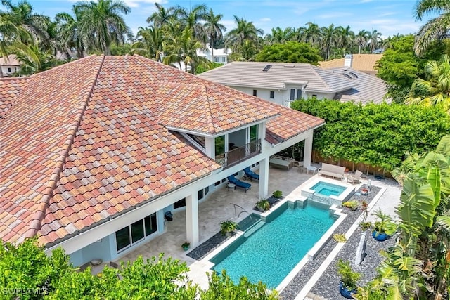 491 Wedge Dr, Naples, FL 34103 - view of swimming pool featuring a patio, a fenced backyard, outdoor lounge area, and a pool with connected hot tub
