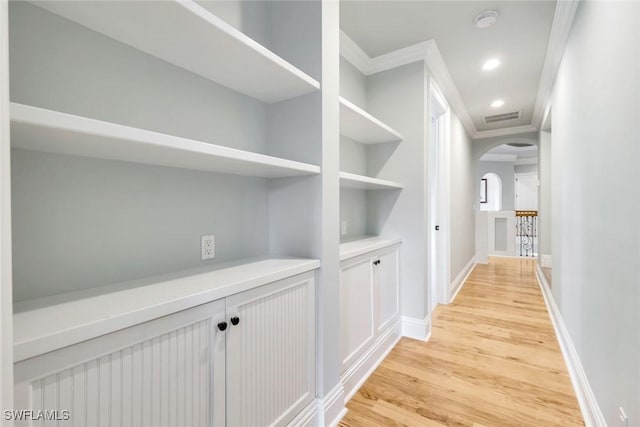 491 Wedge Dr, Naples, FL 34103 - hall featuring arched walkways, crown molding, light wood-type flooring, and recessed lighting