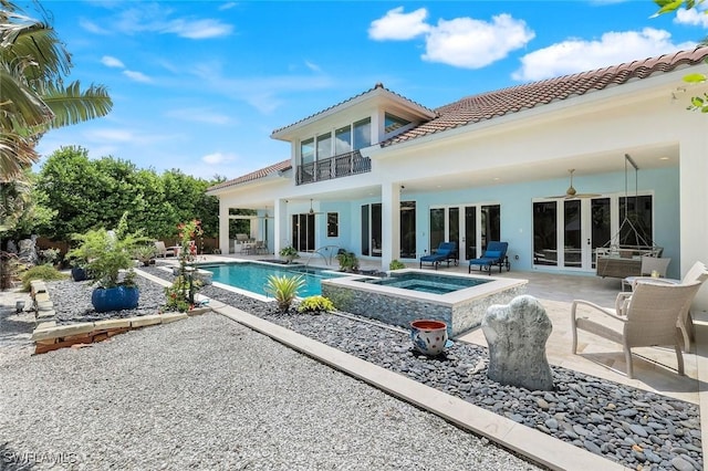 491 Wedge Dr, Naples, FL 34103 - rear view of property featuring an in-ground hot tub, a tiled roof, a patio, french doors, and an outdoor pool