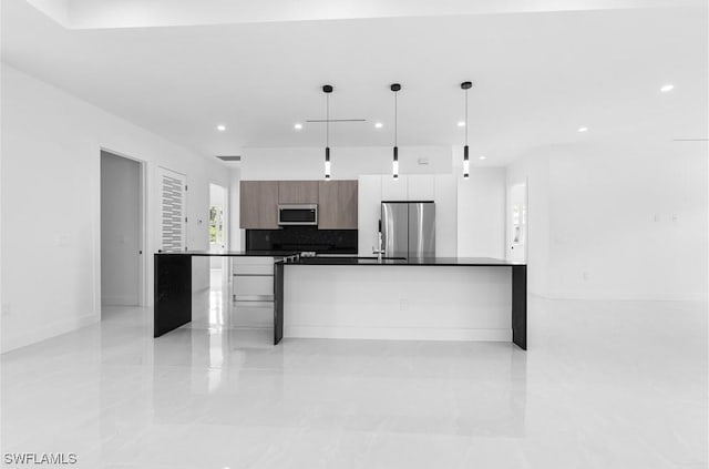 3762 32nd Ave SE, Naples, FL 34117 - kitchen featuring stainless steel appliances, modern cabinets, dark countertops, recessed lighting, and decorative light fixtures