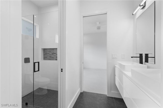 3762 32nd Ave SE, Naples, FL 34117 - full bath featuring a stall shower, double vanity, baseboards, toilet, and tile patterned floors