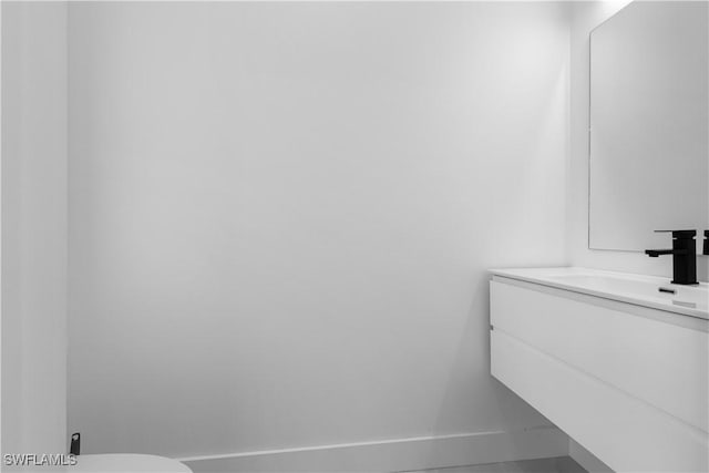 3762 32nd Ave SE, Naples, FL 34117 - half bath with vanity, baseboards, and toilet