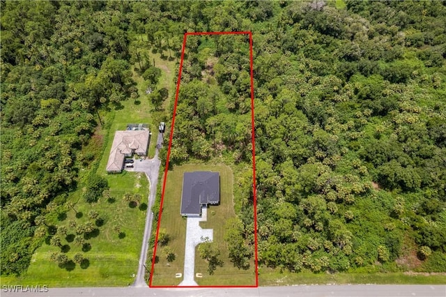 3762 32nd Ave SE, Naples, FL 34117 - aerial view of property and surrounding area featuring property boundaries highlighted and a forest