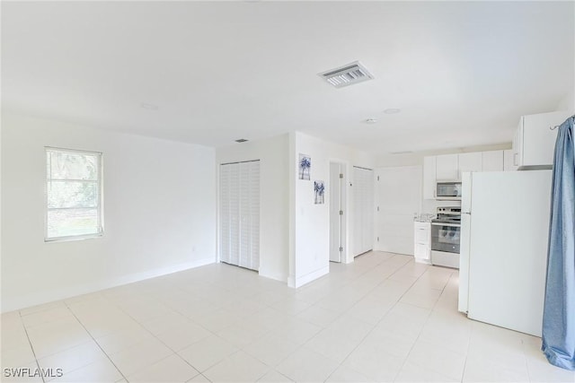 2256 Violet Dr, Fort Myers, FL 33905 - unfurnished living room featuring baseboards