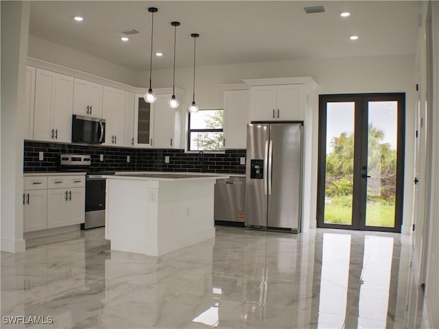 761 Bell Blvd S, Lehigh Acres, FL 33974 - kitchen featuring appliances with stainless steel finishes, french doors, decorative backsplash, a center island, and recessed lighting