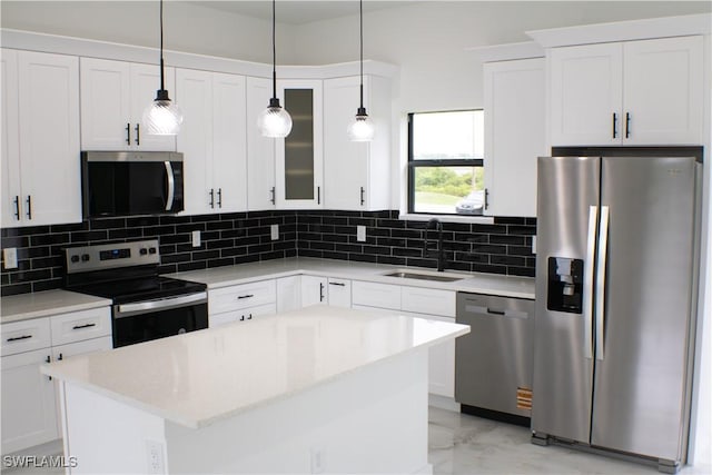 761 Bell Blvd S, Lehigh Acres, FL 33974 - kitchen featuring stainless steel appliances, a sink, decorative backsplash, light marble finish floors, and white cabinetry