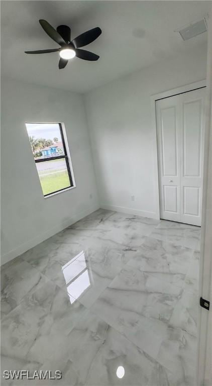 761 Bell Blvd S, Lehigh Acres, FL 33974 - spare room featuring marble finish floors, baseboards, and ceiling fan