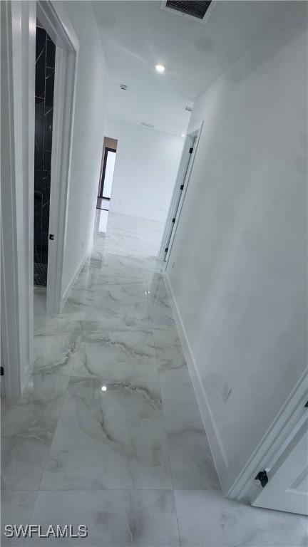 761 Bell Blvd S, Lehigh Acres, FL 33974 - hall featuring baseboards and marble finish flooring