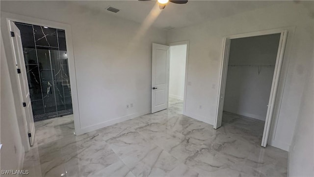 761 Bell Blvd S, Lehigh Acres, FL 33974 - unfurnished bedroom with a walk in closet, marble finish flooring, a closet, and baseboards