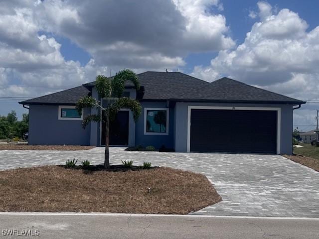 31 Kismet Pkwy E, Cape Coral, FL 33909 - ranch-style house featuring decorative driveway, an attached garage, and stucco siding