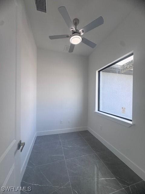 31 Kismet Pkwy E, Cape Coral, FL 33909 - spare room featuring a ceiling fan, dark marble finish floors, and baseboards