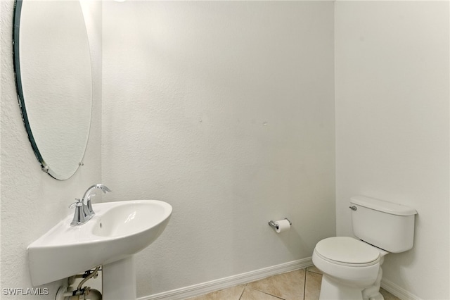 14631 Summer Rose Way, Fort Myers, FL 33919 - bathroom with tile patterned floors, toilet, baseboards, and a sink