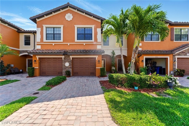 14631 Summer Rose Way, Fort Myers, FL 33919 - townhome / multi-family property with stucco siding, a garage, driveway, and a tile roof