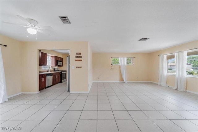 416 Rushmore Ave S, Lehigh Acres, FL 33936 - unfurnished living room featuring baseboards, ceiling fan, light tile patterned floors, and a sink