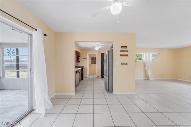 416 Rushmore Ave S, Lehigh Acres, FL 33936 - spare room featuring a ceiling fan, baseboards, and light tile patterned flooring