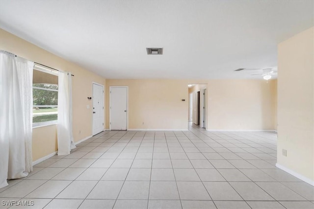 416 Rushmore Ave S, Lehigh Acres, FL 33936 - unfurnished room with baseboards, a ceiling fan, and light tile patterned flooring