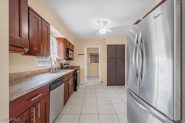 416 Rushmore Ave S, Lehigh Acres, FL 33936 - kitchen with appliances with stainless steel finishes, a sink, ceiling fan, light tile patterned floors, and baseboards