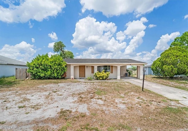 416 Rushmore Ave S, Lehigh Acres, FL 33936 - single story home with a carport, driveway, and stucco siding