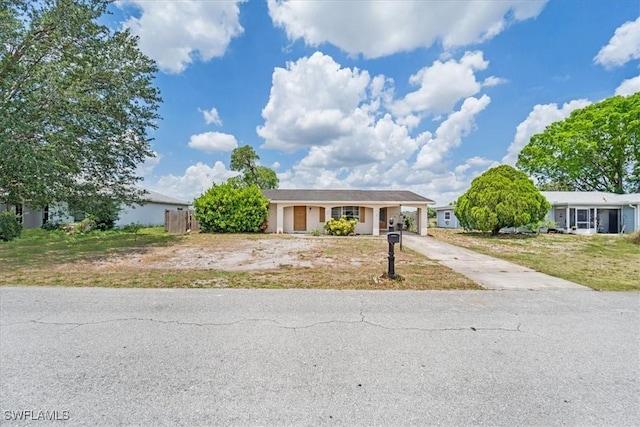 416 Rushmore Ave S, Lehigh Acres, FL 33936 - ranch-style home with concrete driveway