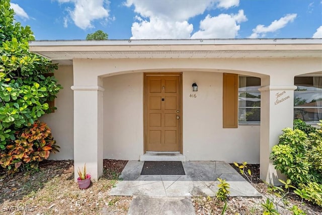 416 Rushmore Ave S, Lehigh Acres, FL 33936 - view of exterior entry with stucco siding