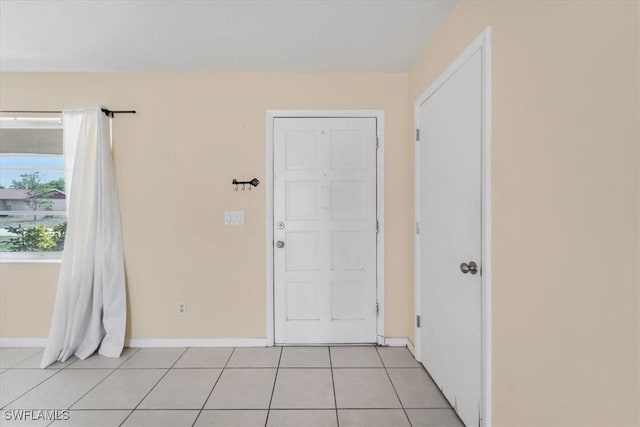 416 Rushmore Ave S, Lehigh Acres, FL 33936 - entrance foyer with light tile patterned flooring and baseboards