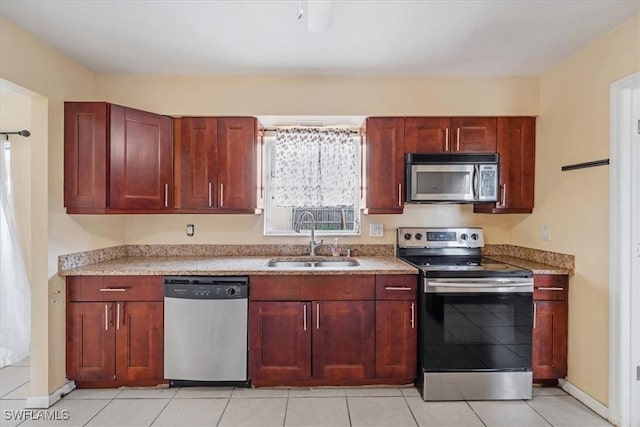 416 Rushmore Ave S, Lehigh Acres, FL 33936 - kitchen featuring appliances with stainless steel finishes, a sink, light countertops, and reddish brown cabinets