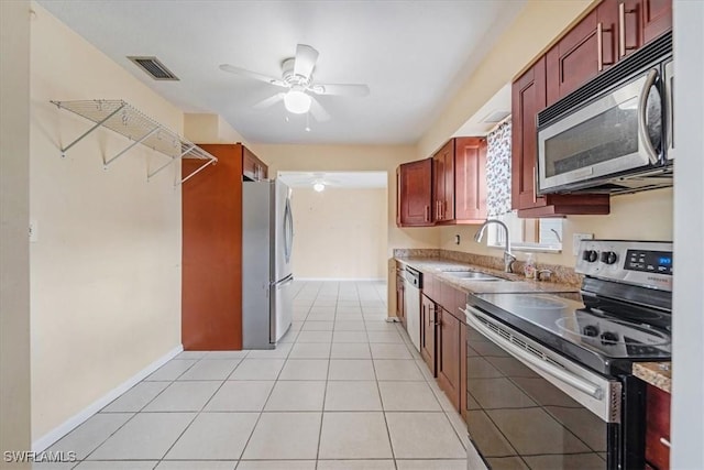 416 Rushmore Ave S, Lehigh Acres, FL 33936 - kitchen with appliances with stainless steel finishes, ceiling fan, a sink, light tile patterned floors, and light countertops