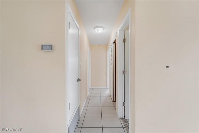 416 Rushmore Ave S, Lehigh Acres, FL 33936 - hall with light tile patterned flooring and baseboards