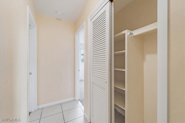 416 Rushmore Ave S, Lehigh Acres, FL 33936 - corridor featuring light tile patterned floors and baseboards