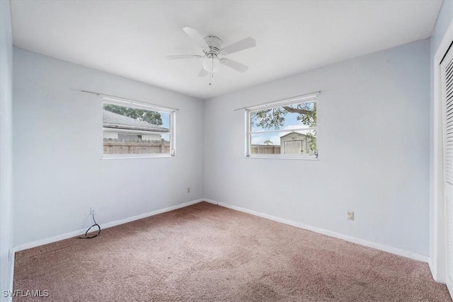 416 Rushmore Ave S, Lehigh Acres, FL 33936 - unfurnished bedroom featuring carpet flooring, multiple windows, a closet, and baseboards