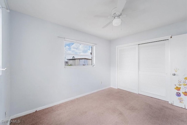 416 Rushmore Ave S, Lehigh Acres, FL 33936 - unfurnished bedroom with carpet, a closet, baseboards, and ceiling fan