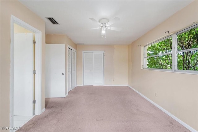 416 Rushmore Ave S, Lehigh Acres, FL 33936 - unfurnished bedroom with carpet flooring, baseboards, a ceiling fan, and two closets