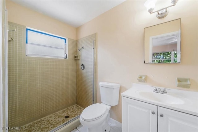 416 Rushmore Ave S, Lehigh Acres, FL 33936 - bathroom with vanity, toilet, healthy amount of natural light, and a tile shower