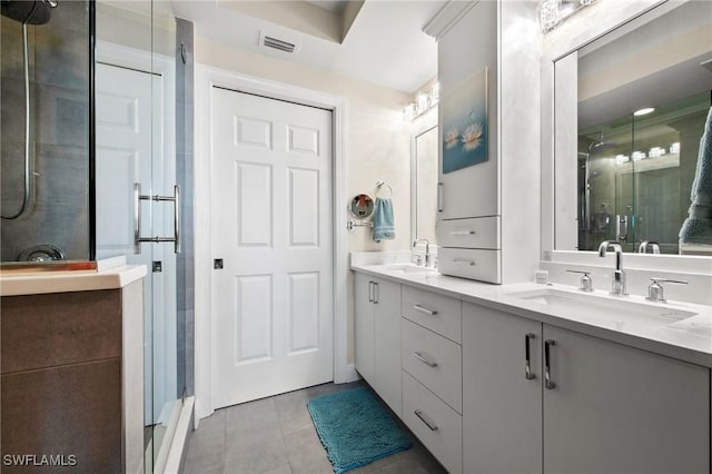2745 1st St Unit 1602, Fort Myers, FL 33916 - bathroom featuring a stall shower, double vanity, and tile patterned flooring