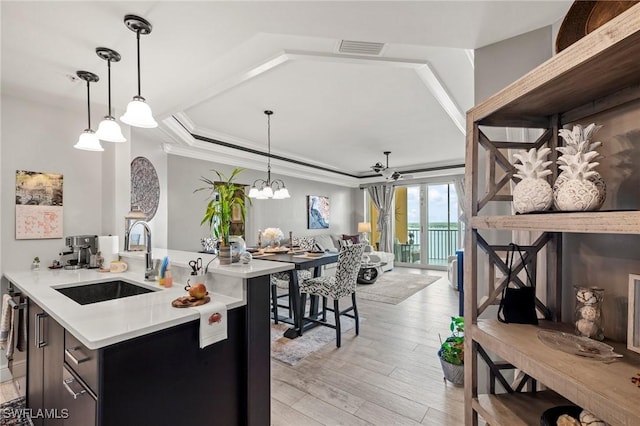 2745 1st St Unit 1602, Fort Myers, FL 33916 - kitchen featuring a sink, light wood-style flooring, light countertops, open floor plan, and decorative light fixtures