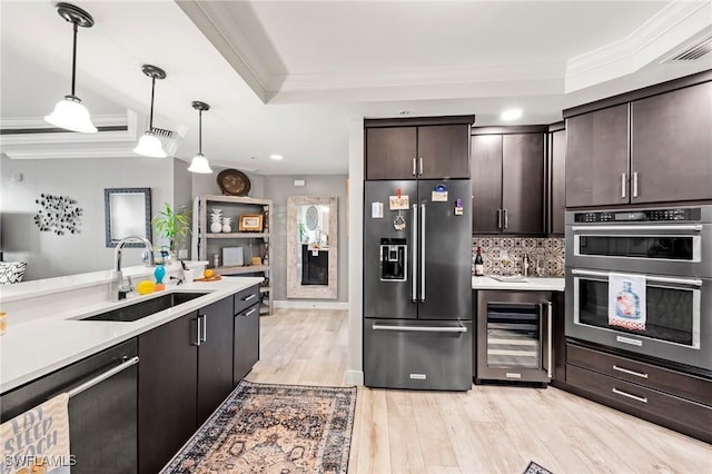 2745 1st St Unit 1602, Fort Myers, FL 33916 - kitchen featuring stainless steel appliances, beverage cooler, a sink, ornamental molding, and light wood-style floors