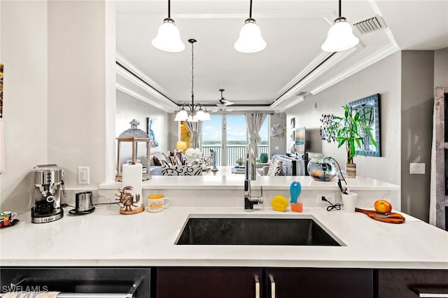 2745 1st St Unit 1602, Fort Myers, FL 33916 - kitchen featuring a sink, dishwashing machine, ornamental molding, open floor plan, and hanging light fixtures
