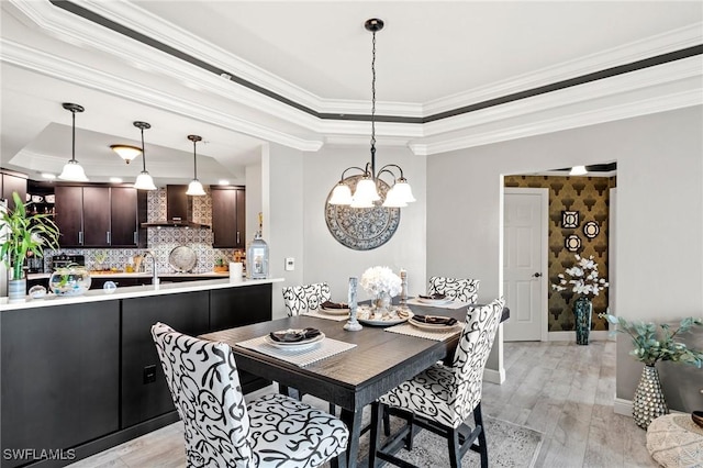 2745 1st St Unit 1602, Fort Myers, FL 33916 - dining space with a tray ceiling, a chandelier, light wood-style floors, crown molding, and baseboards