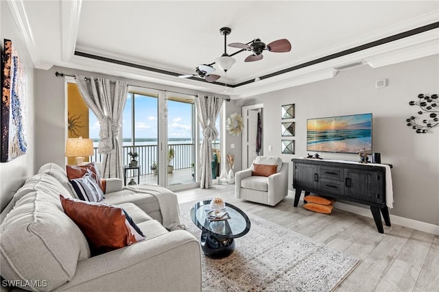 2745 1st St Unit 1602, Fort Myers, FL 33916 - living room with ceiling fan, a tray ceiling, ornamental molding, light wood-style floors, and baseboards