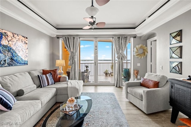 2745 1st St Unit 1602, Fort Myers, FL 33916 - living area featuring a raised ceiling, crown molding, light wood-type flooring, a water view, and arched walkways