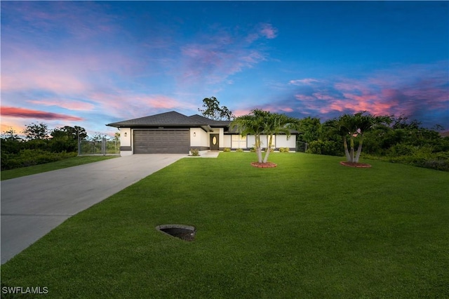 3304 44th St SW, Lehigh Acres, FL 33976 - view of front of property featuring concrete driveway, a garage, a lawn, and stucco siding
