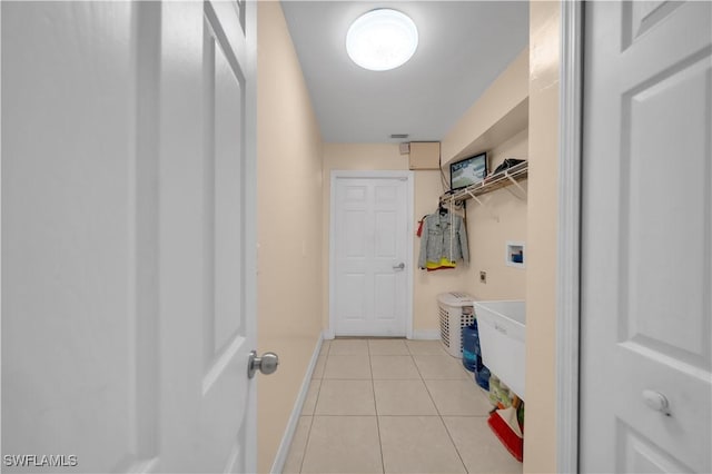 3304 44th St SW, Lehigh Acres, FL 33976 - washroom featuring hookup for a washing machine, light tile patterned floors, and baseboards