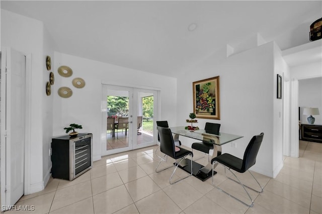 3304 44th St SW, Lehigh Acres, FL 33976 - dining room featuring french doors, wine cooler, light tile patterned floors, vaulted ceiling, and baseboards