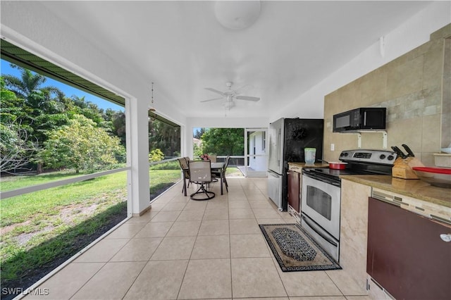 3304 44th St SW, Lehigh Acres, FL 33976 - kitchen with appliances with stainless steel finishes, light tile patterned floors, and ceiling fan