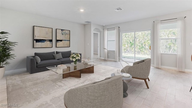 2013 NE 6th Ave, Cape Coral, FL 33909 - living area featuring arched walkways, baseboards, and recessed lighting